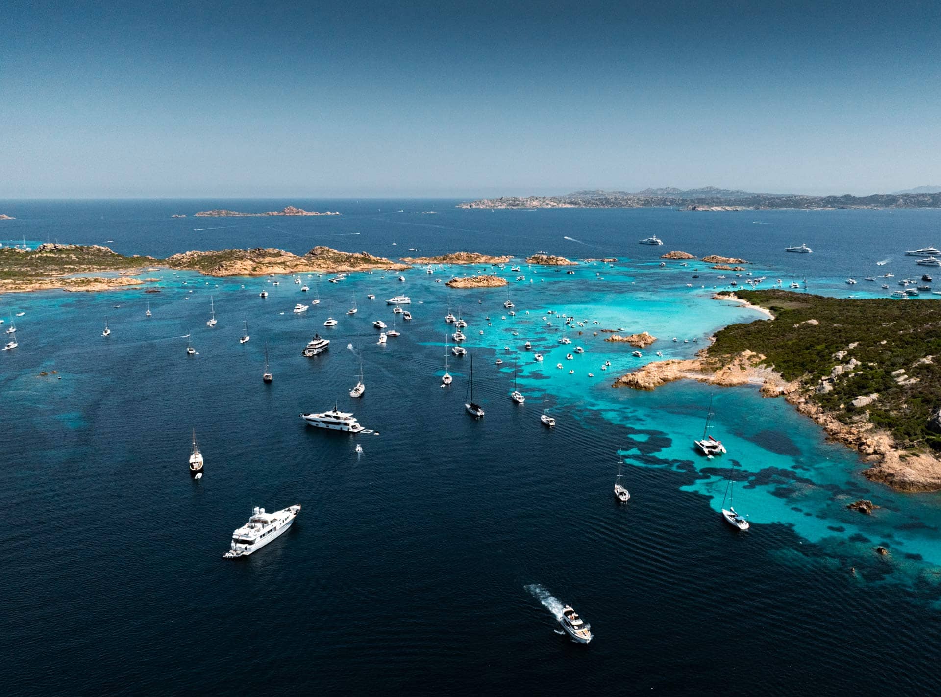 The sea in Italy, dotted with a variety of different-sized boats