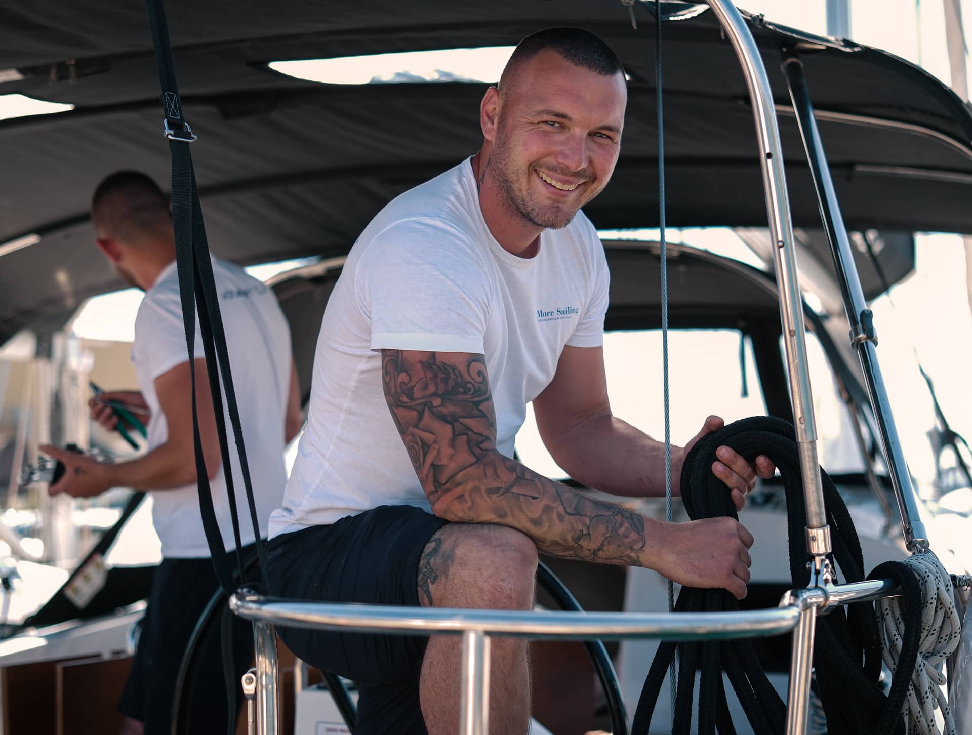 A technician from Croatia smiles at us while he works on the boat