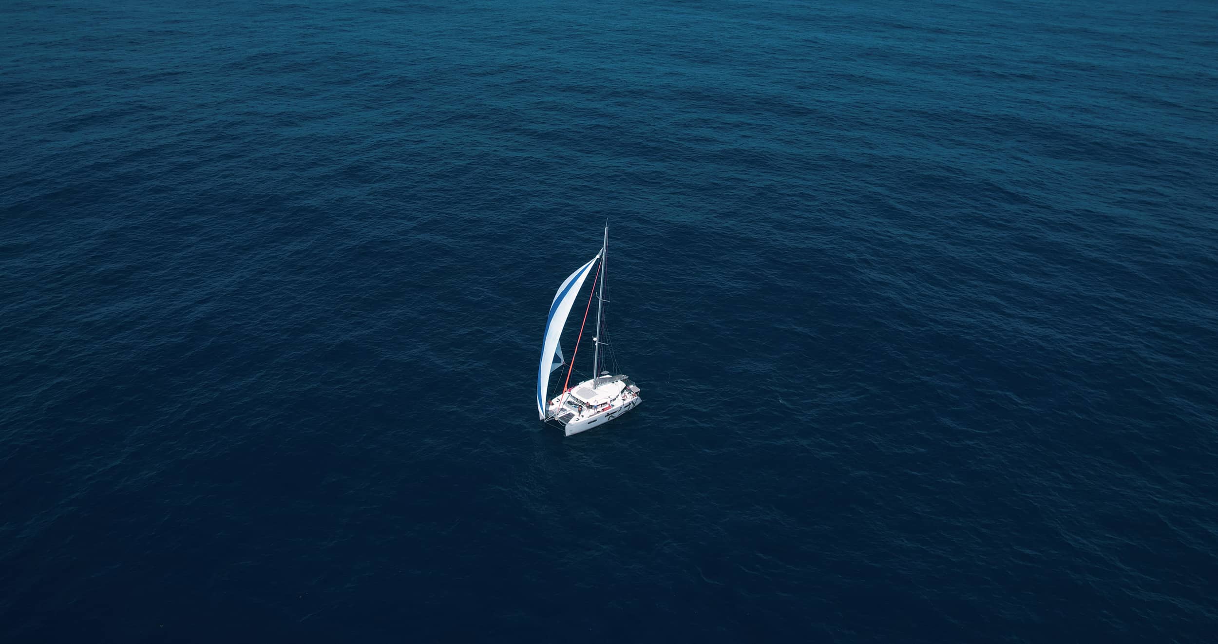 Et billede af en sejlbåd midt i det åbne hav.