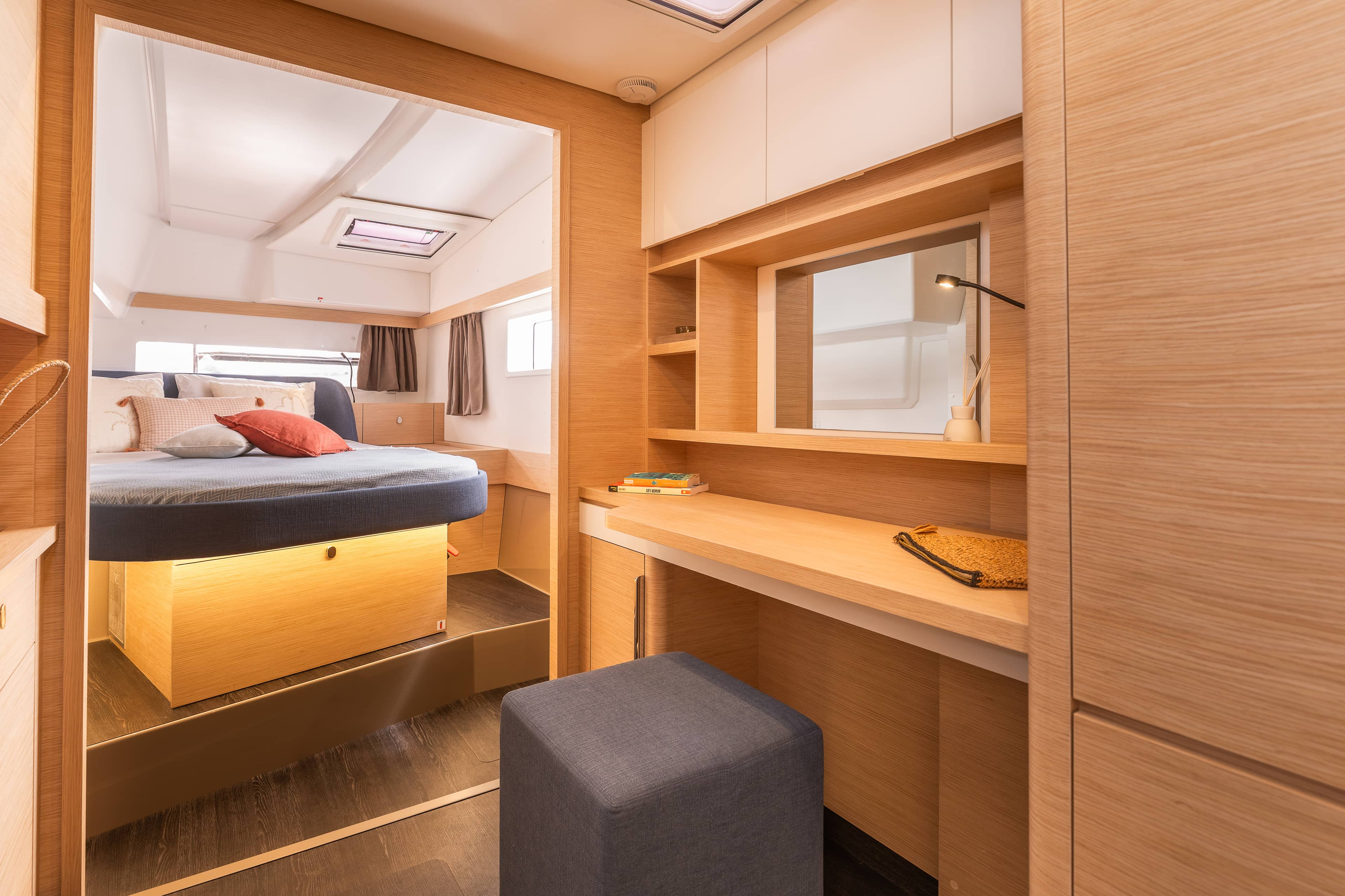 Saloon with sofa and table in grey fabric on board a catamaran.