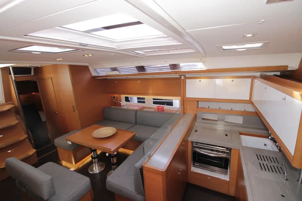 Saloon with grey and wooden furnishings on the Dufour 530 monohull.