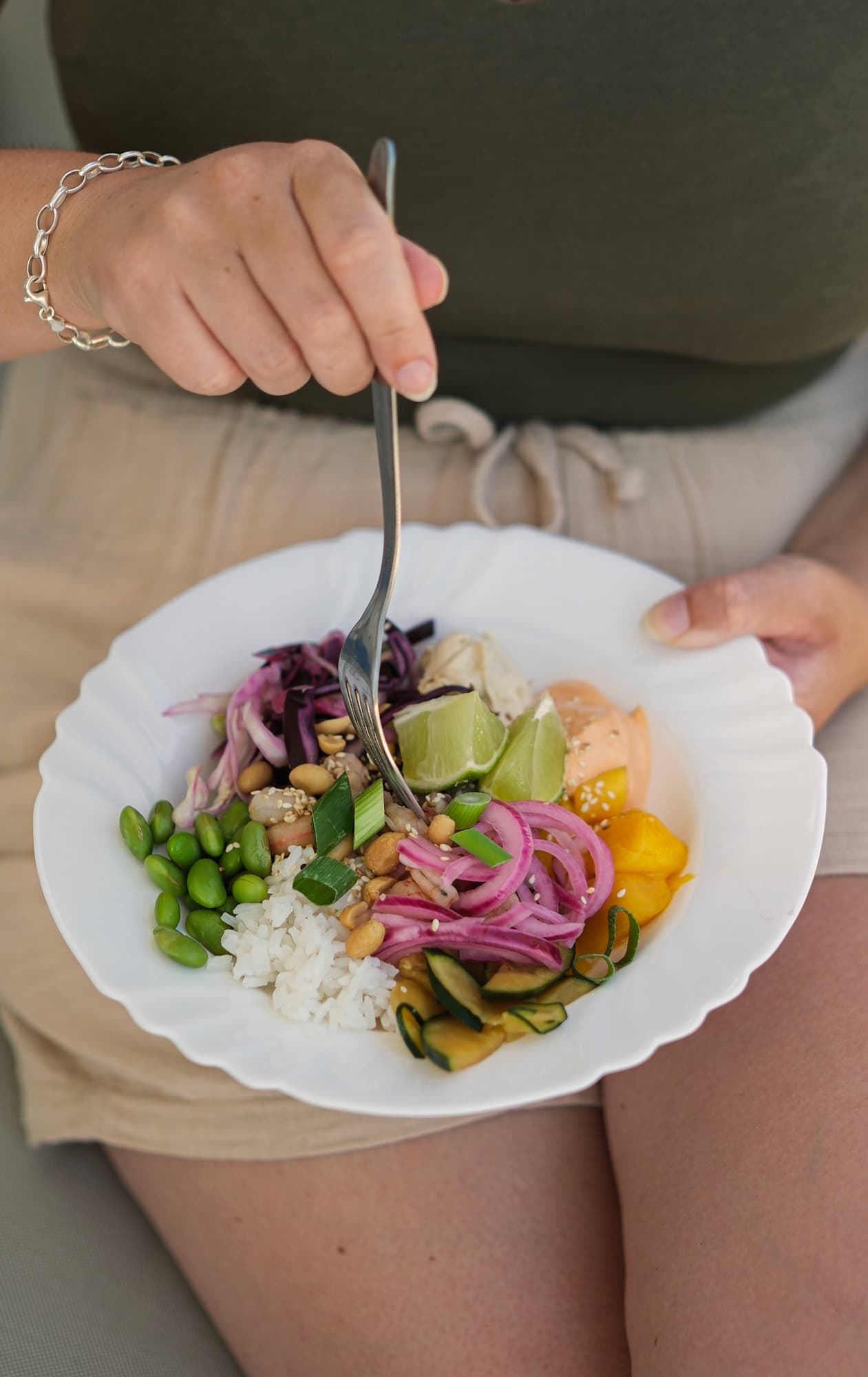 Colourful poke bowl with rice, vegetables and prawns