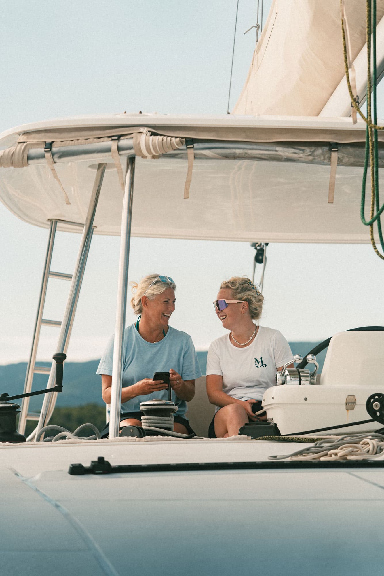 A skipper shows a guest how to sail