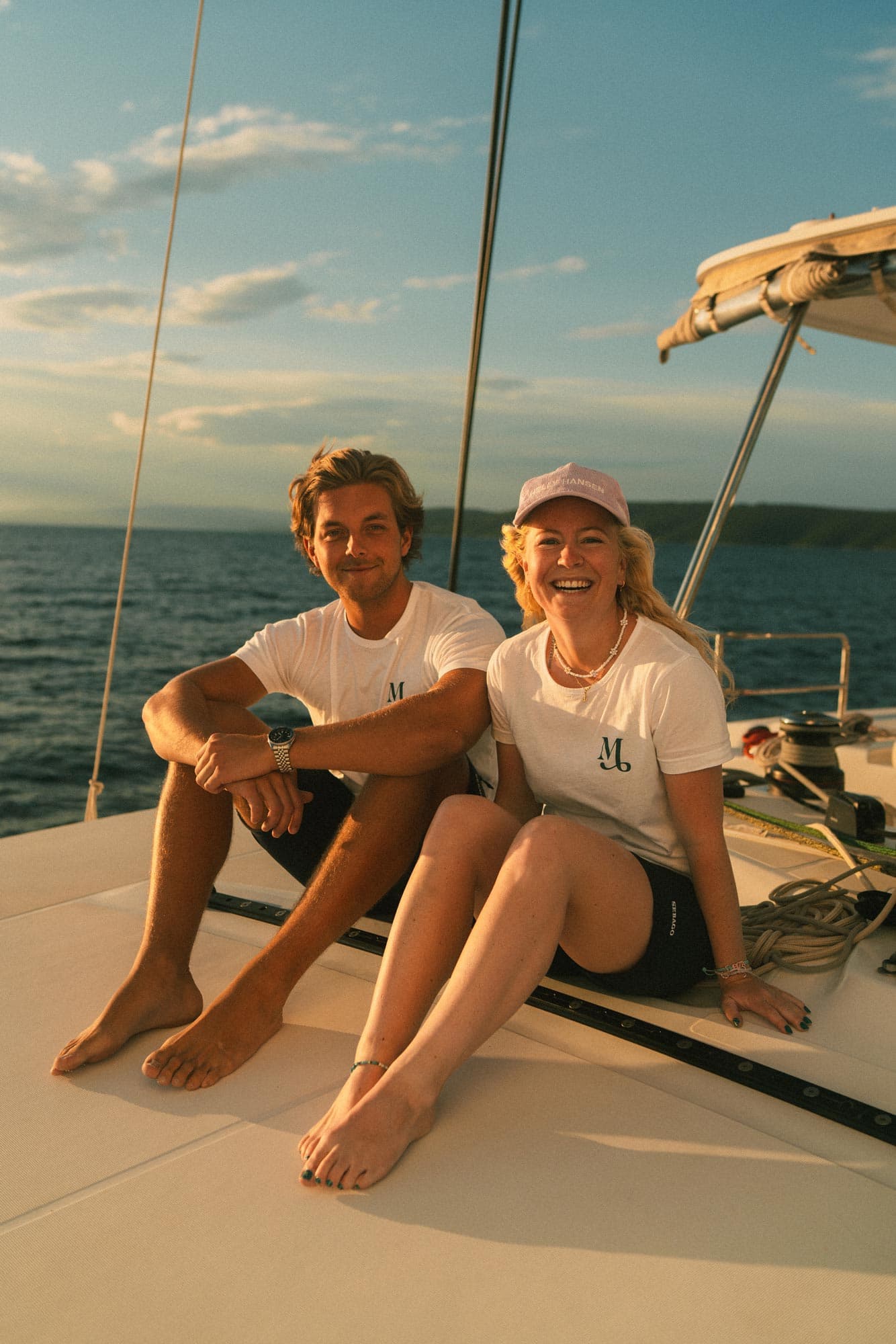 Skipper og vært sidder og nyder solnedgangen på sejlbåden