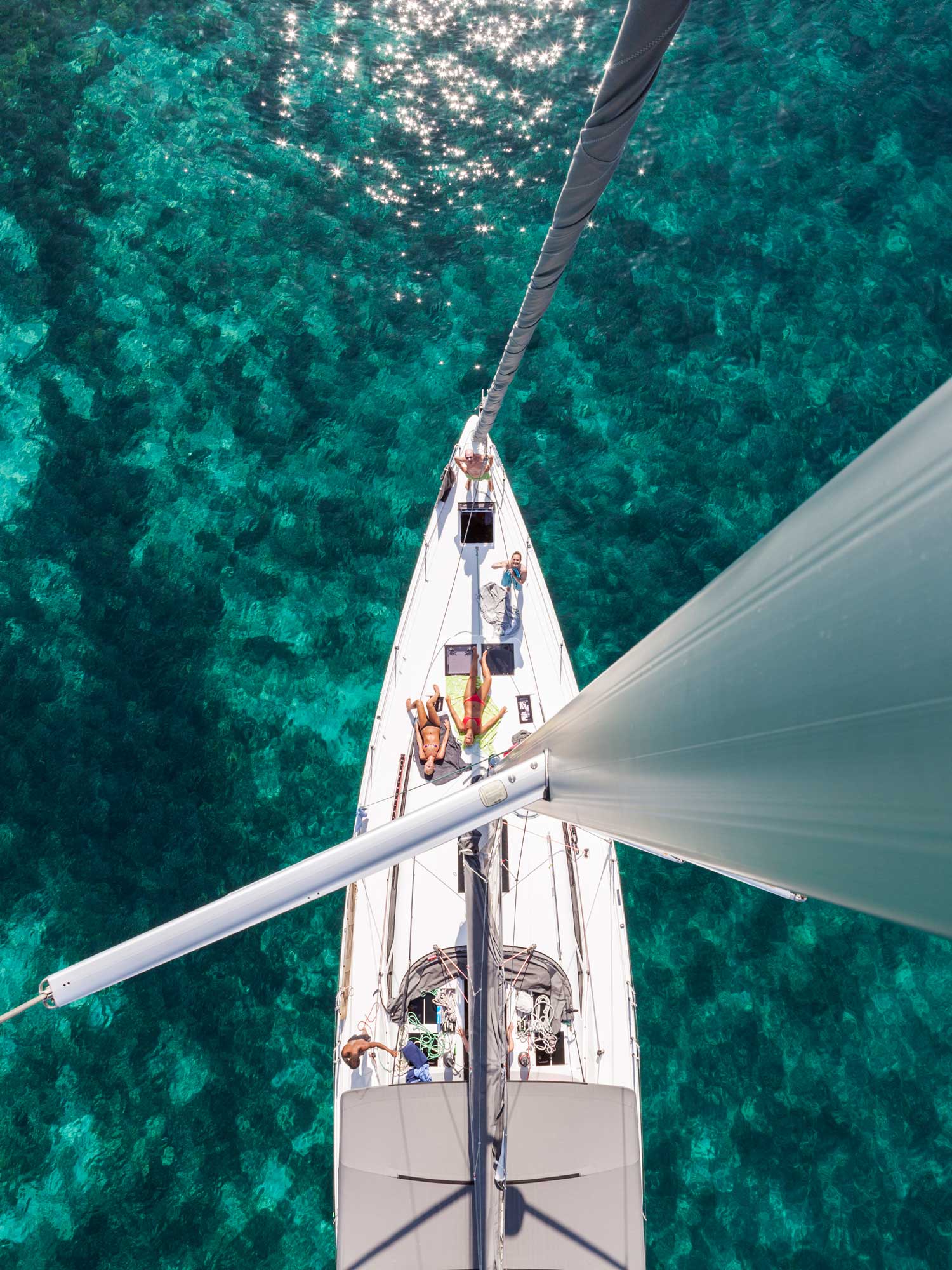 Aerial view of a sailing boat with sunbathing guests