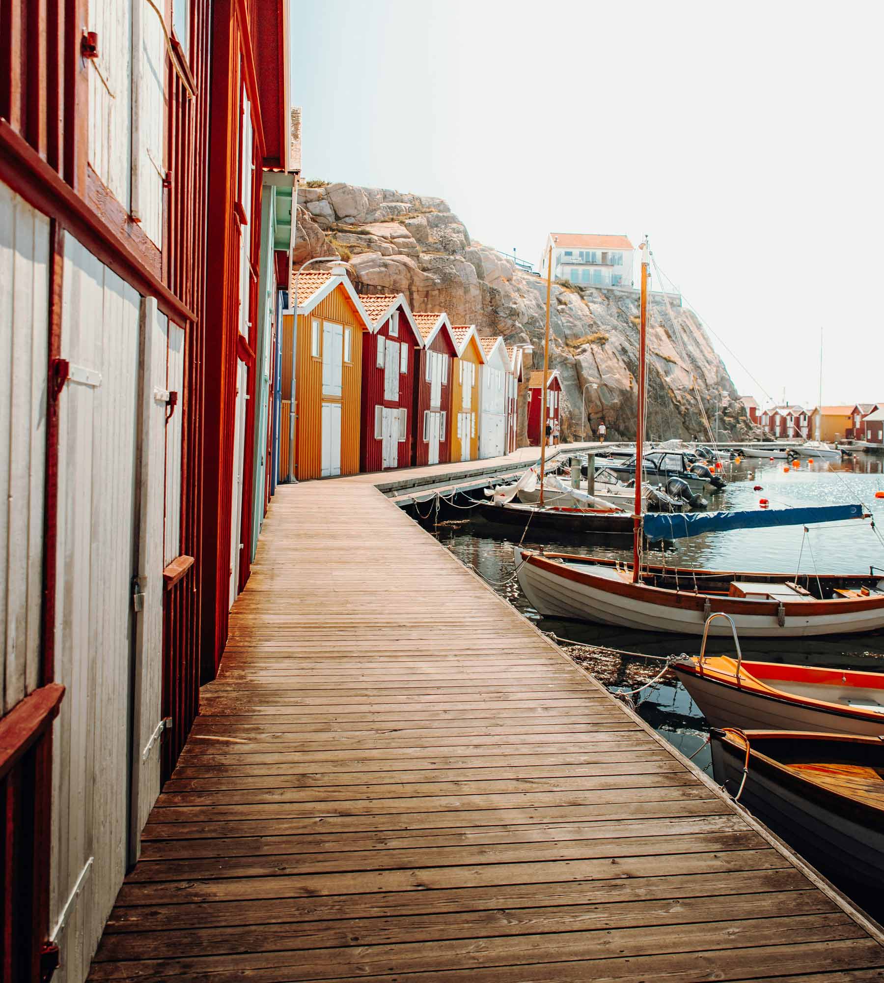 A jetty along Smögen harbour, with lots of red and yellow fishing huts