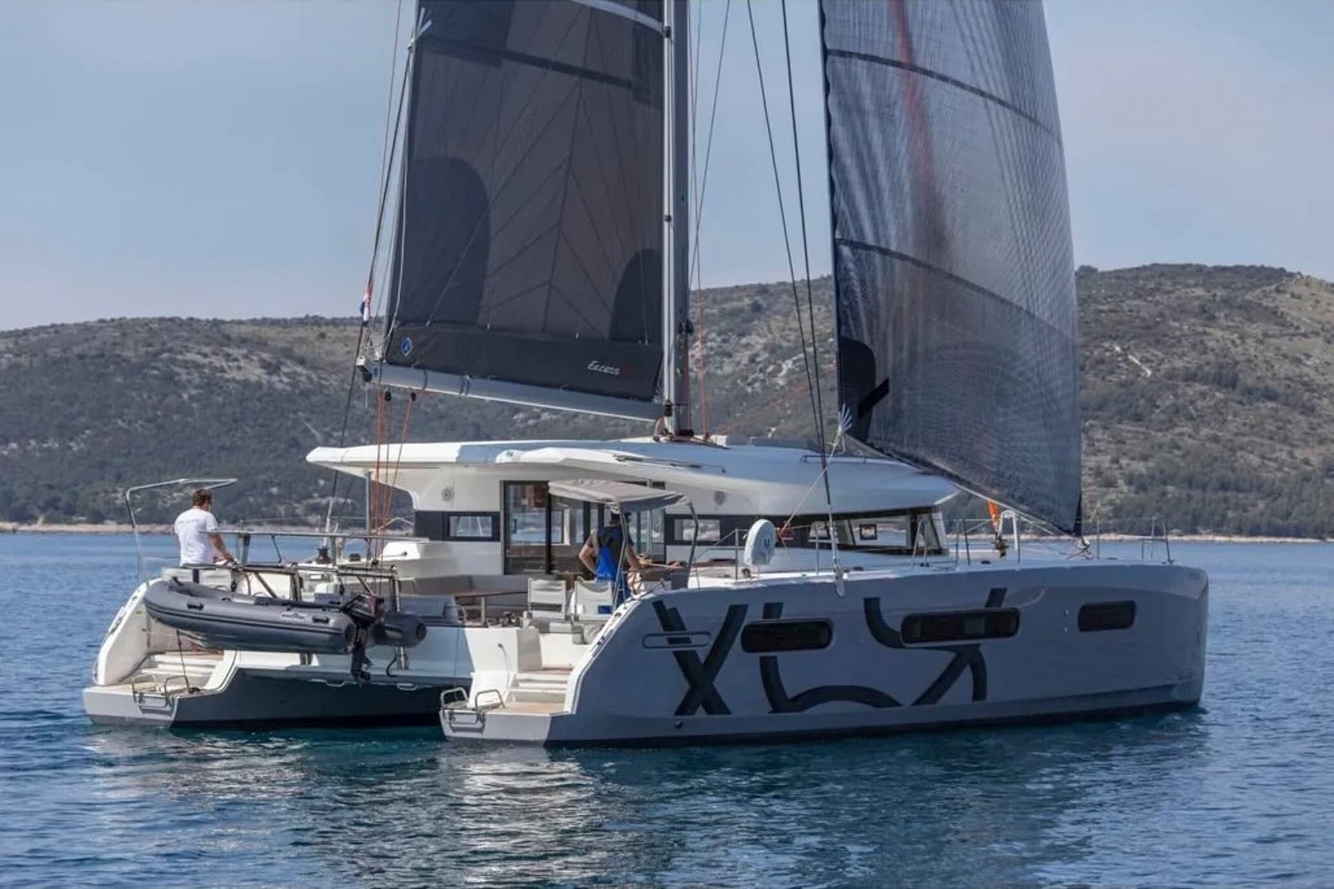 The Excess 15 catamaran out at sea with sails hoisted.