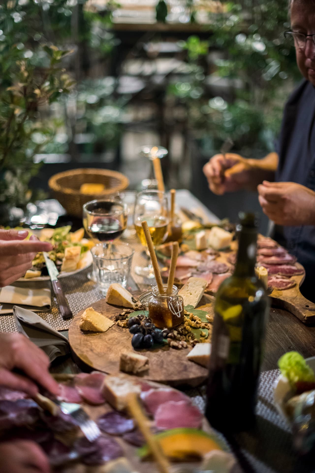 A grazing board with cold cuts, cheese and wine.