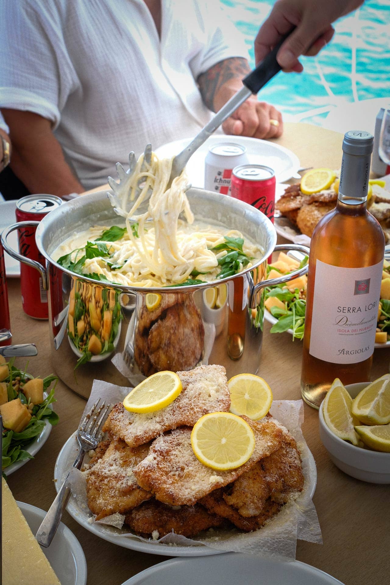 Pasta al limone with parmesan breaded chicken, bottle of rosé and Coca-Cola