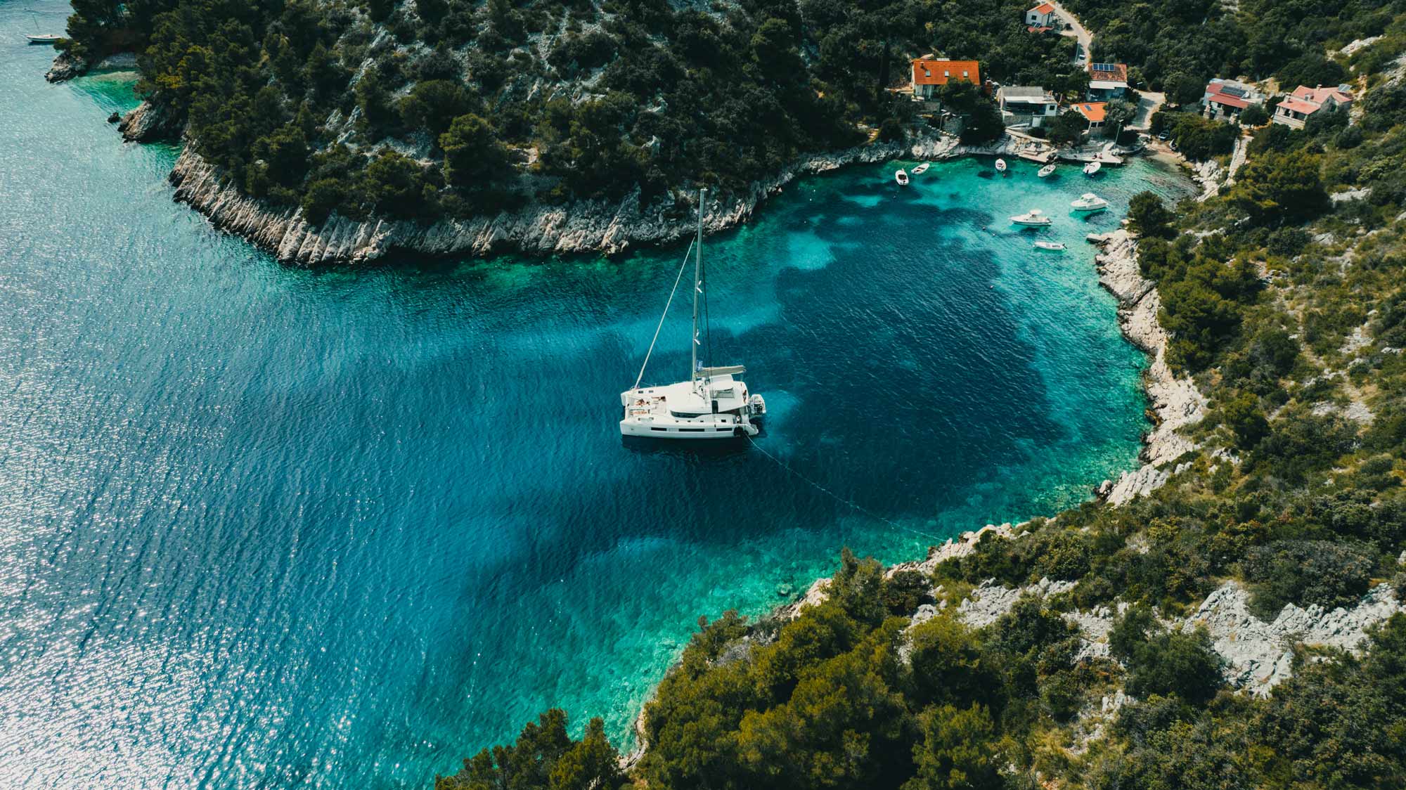 A catamaran anchored in a turquoise bay in Croatia