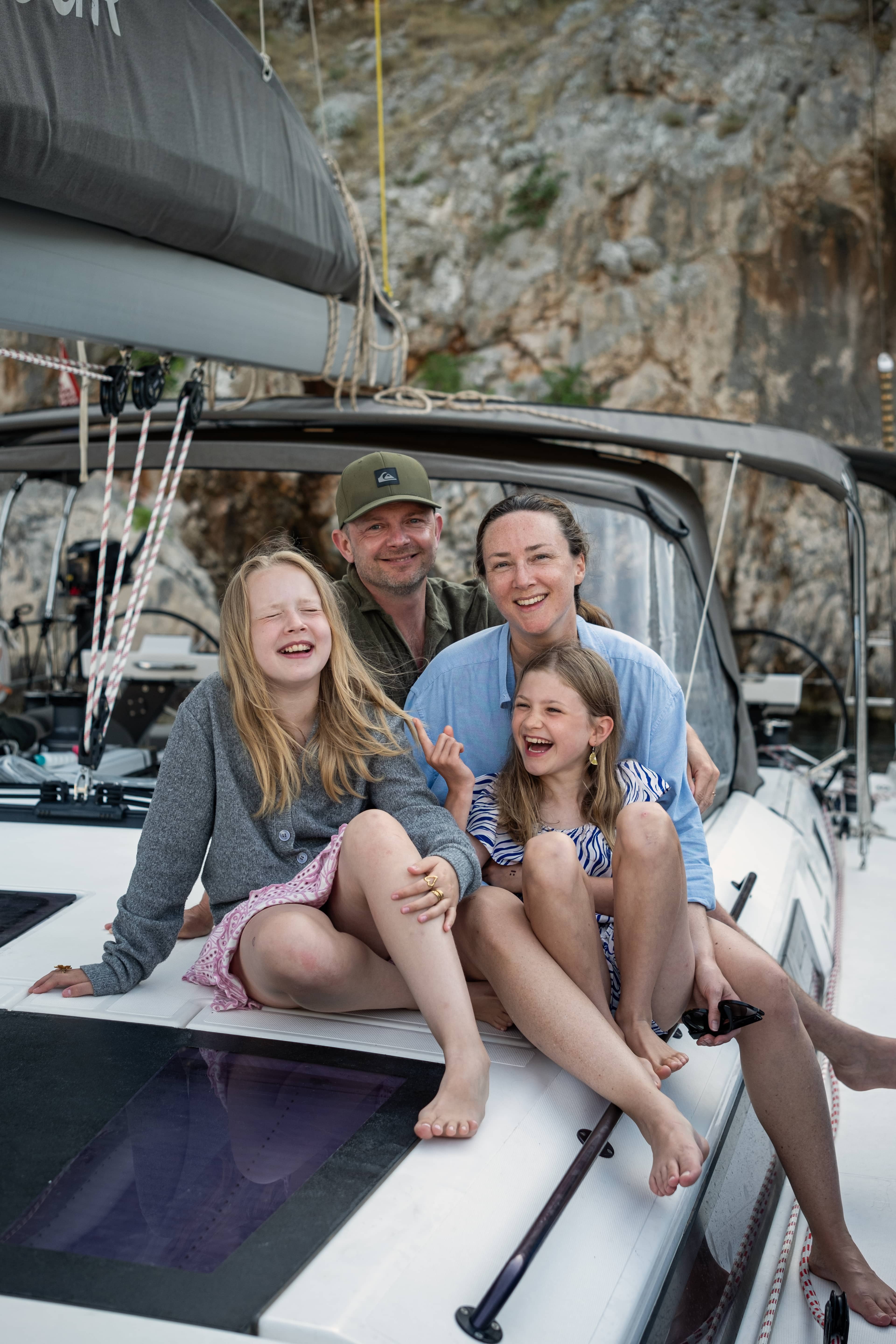 2 adults and 2 children sit on deck